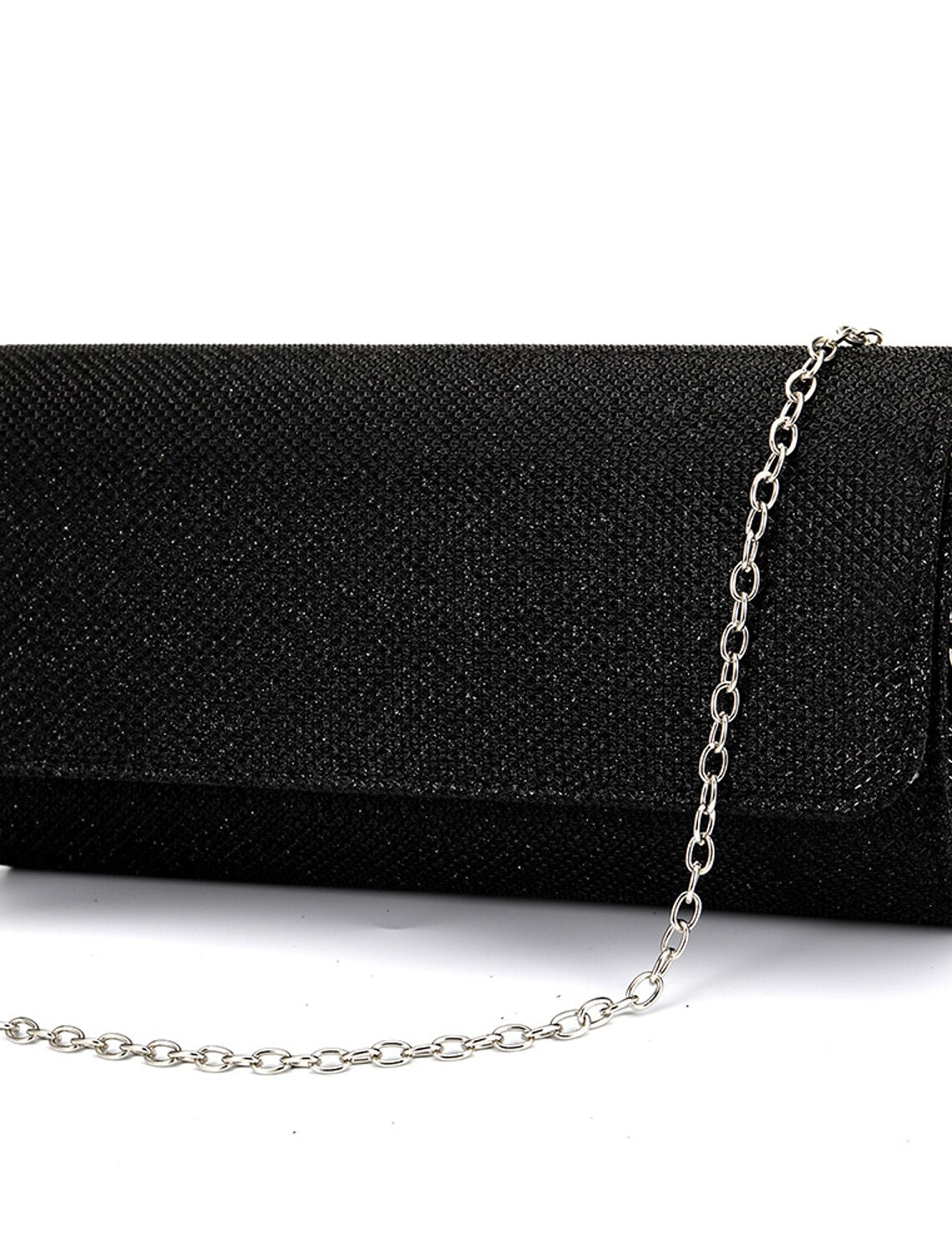 Evening clutch bag with its chain strap extended for versatile carrying.