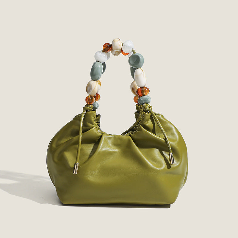 Side view of the chic evening clutch, showcasing its structured design.