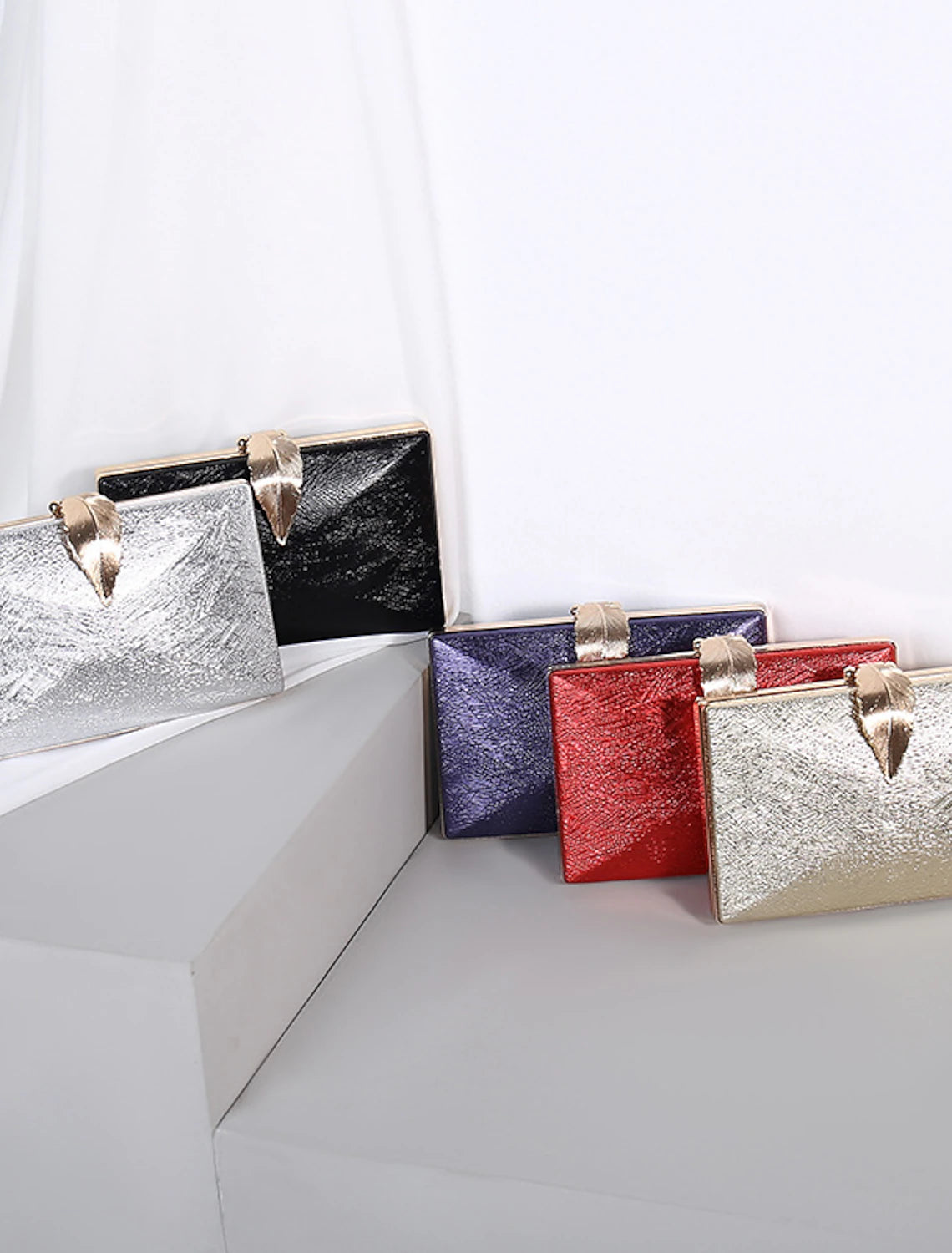 Elegant solid color polyester clutch bag with a delicate chain strap.