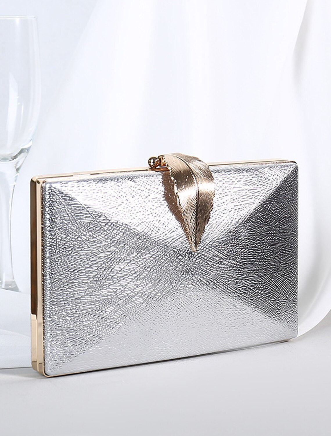 Bridal or wedding guest clutch purse, held gracefully for a special occasion.
