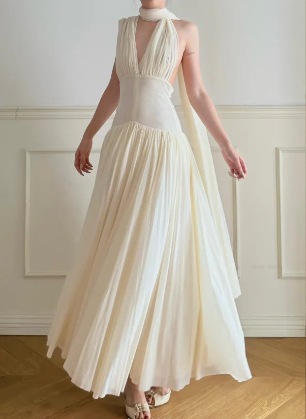 Elegant Cream Halter Neck Prom Dress With Deep V Neck Open Back And Flowy Maxi Skirt For Formal Evening Party