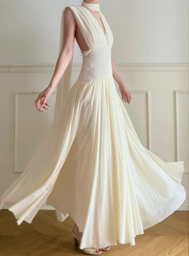 Elegant Cream Halter Neck Prom Dress With Deep V Neck Open Back And Flowy Maxi Skirt For Formal Evening Party