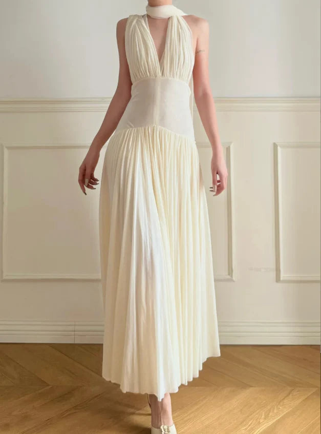 Elegant Cream Halter Neck Prom Dress With Deep V Neck Open Back And Flowy Maxi Skirt For Formal Evening Party
