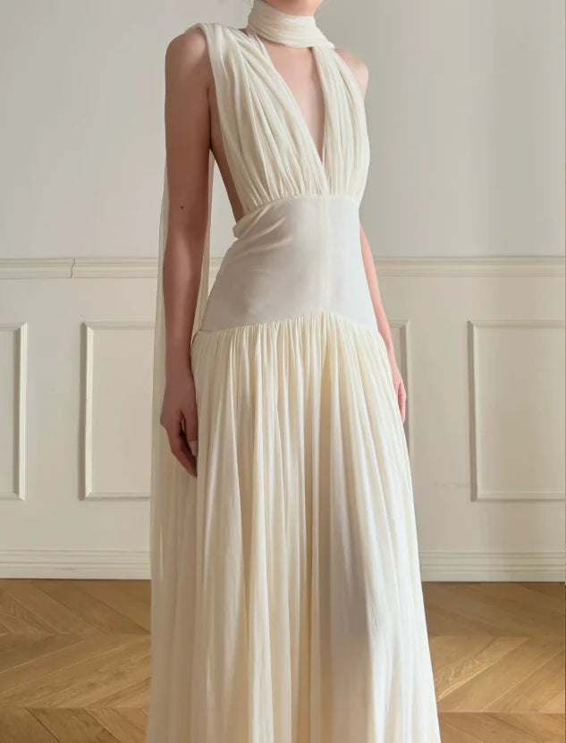 Elegant Cream Halter Neck Prom Dress With Deep V Neck Open Back And Flowy Maxi Skirt For Formal Evening Party