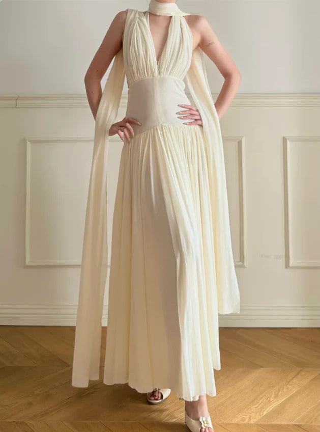 Elegant Cream Halter Neck Prom Dress With Deep V Neck Open Back And Flowy Maxi Skirt For Formal Evening Party