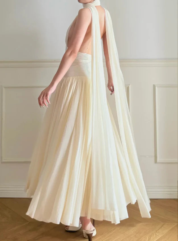 Elegant Cream Halter Neck Prom Dress With Deep V Neck Open Back And Flowy Maxi Skirt For Formal Evening Party