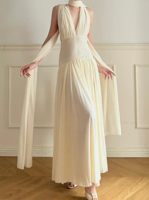 Elegant Cream Halter Neck Prom Dress With Deep V Neck Open Back And Flowy Maxi Skirt For Formal Evening Party