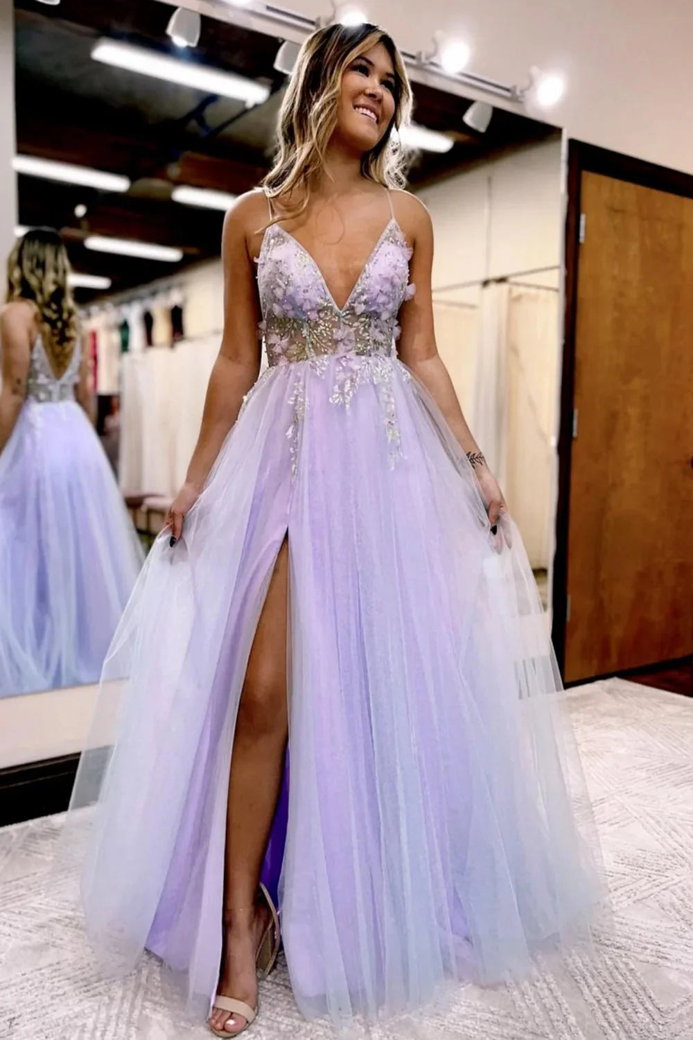A-line light blue tulle prom dress with floral embellishments and V-neckline.