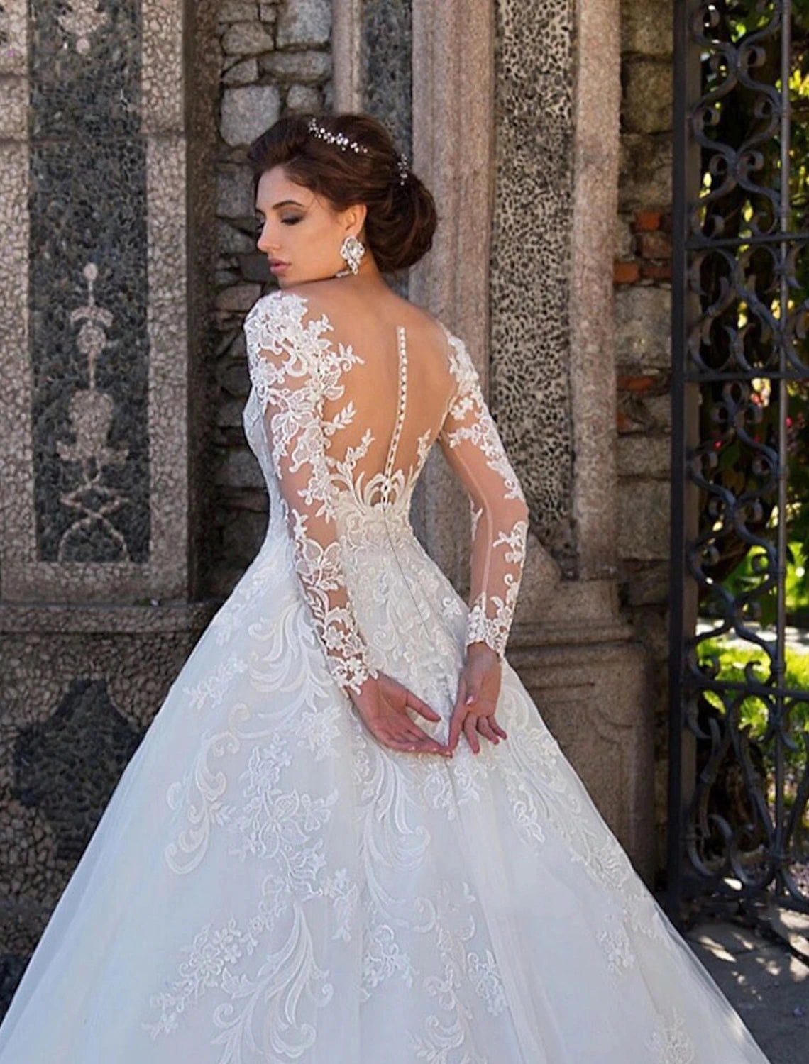 Back view of a bridal ball gown featuring a court train and lace appliques.
