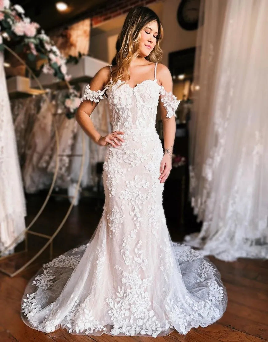 Mermaid off-shoulder wedding dress with intricate 3D floral appliques.