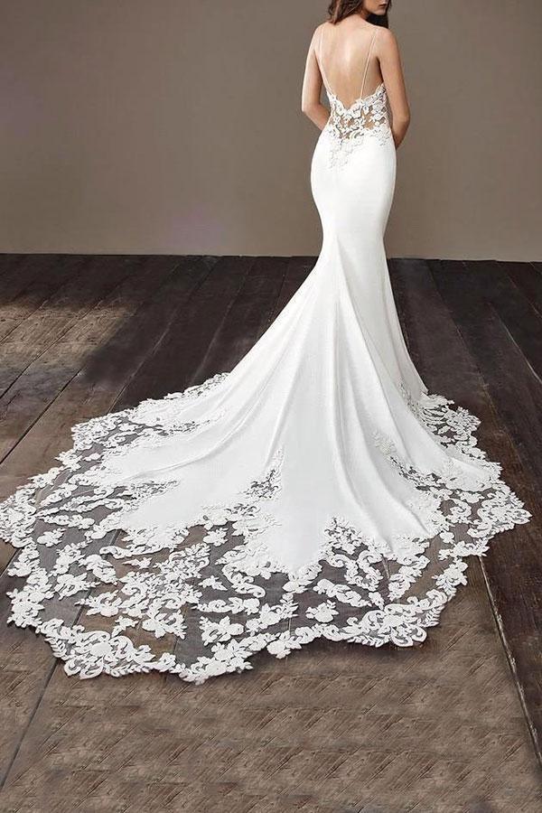 Close-up of the intricate applique details on a fitted mermaid bridal gown.
