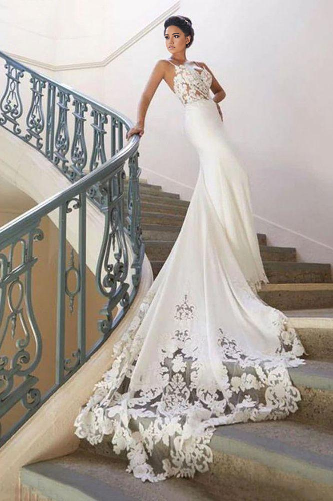 Full view of a bride wearing an elegant mermaid spaghetti strap wedding dress.