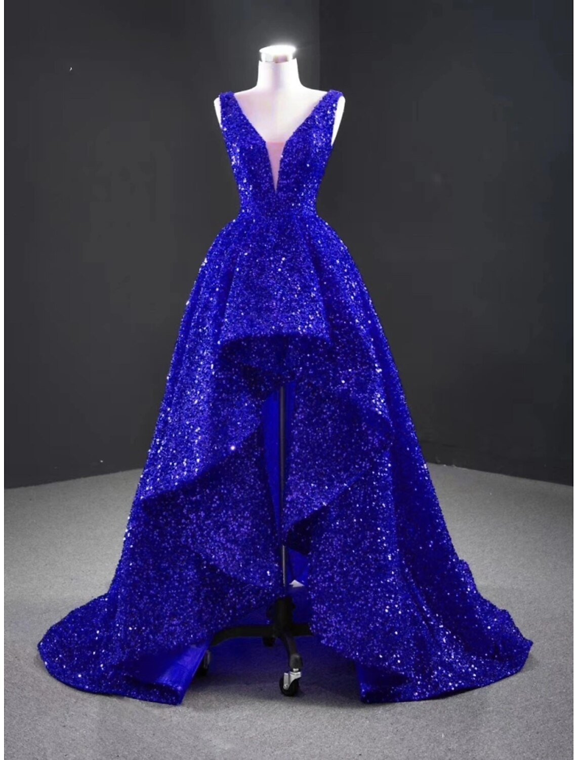 Close-up of the sequined and pleated details on the A-line evening gown.