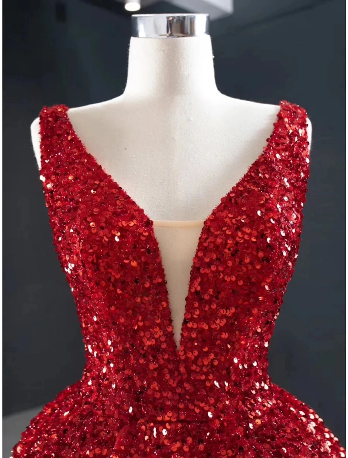 Back view of the A-line V-neck sequined evening gown showing the sweep train.