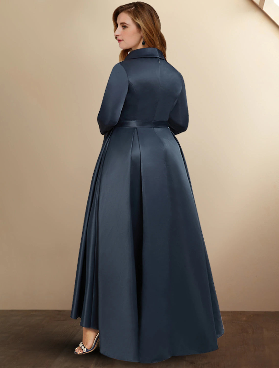 Side view of A-line dress with 3/4 sleeves and pleated skirt.