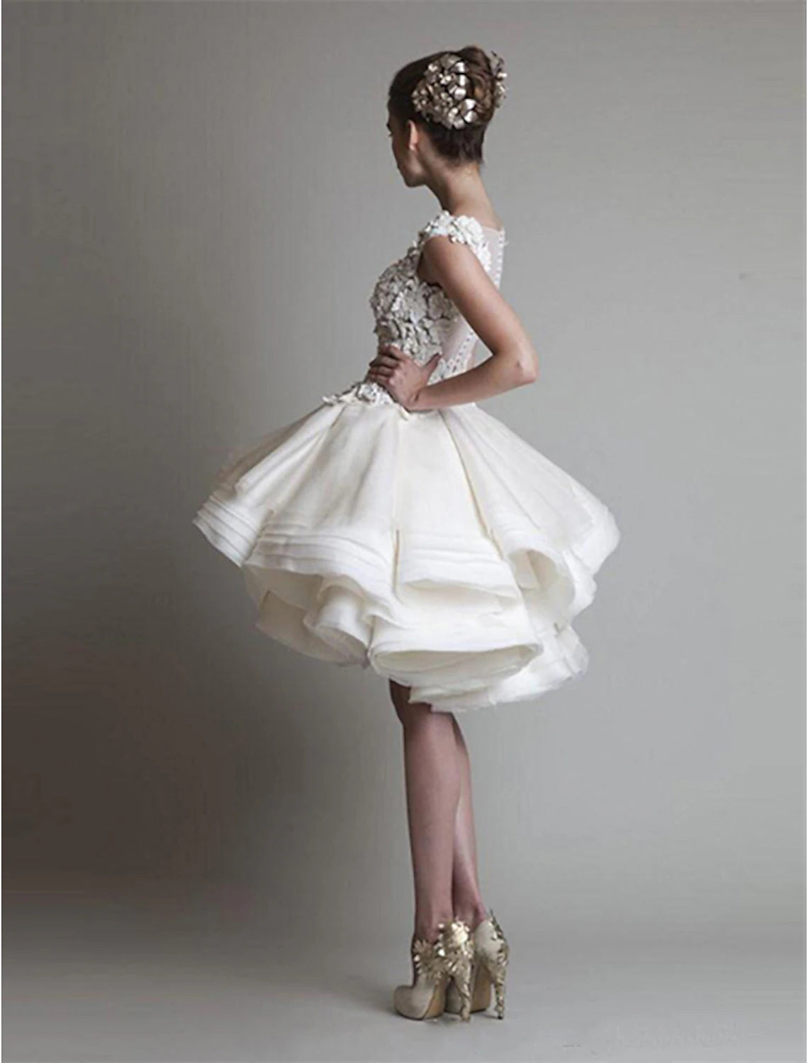 Back view of white tiered organza mini dress.