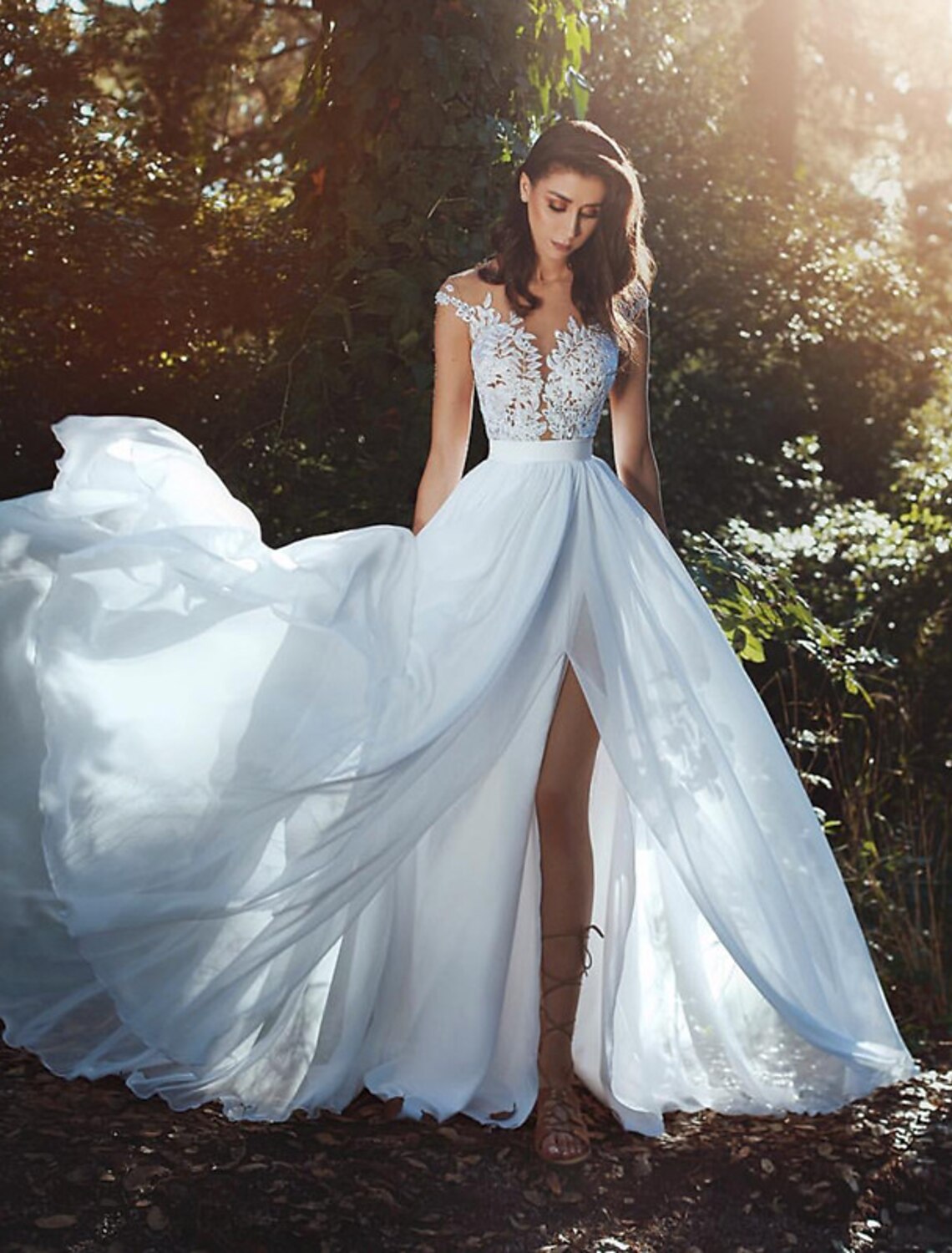 A-Line chiffon wedding dress with cap sleeves and illusion neckline.