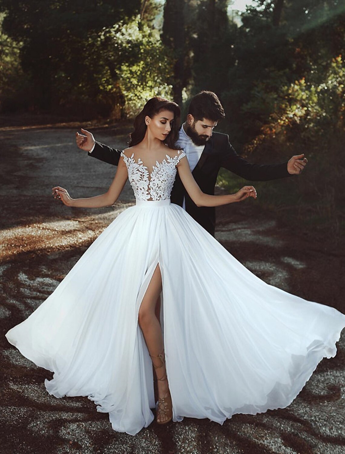 Side view of A-Line wedding dress showing pleats and court train.