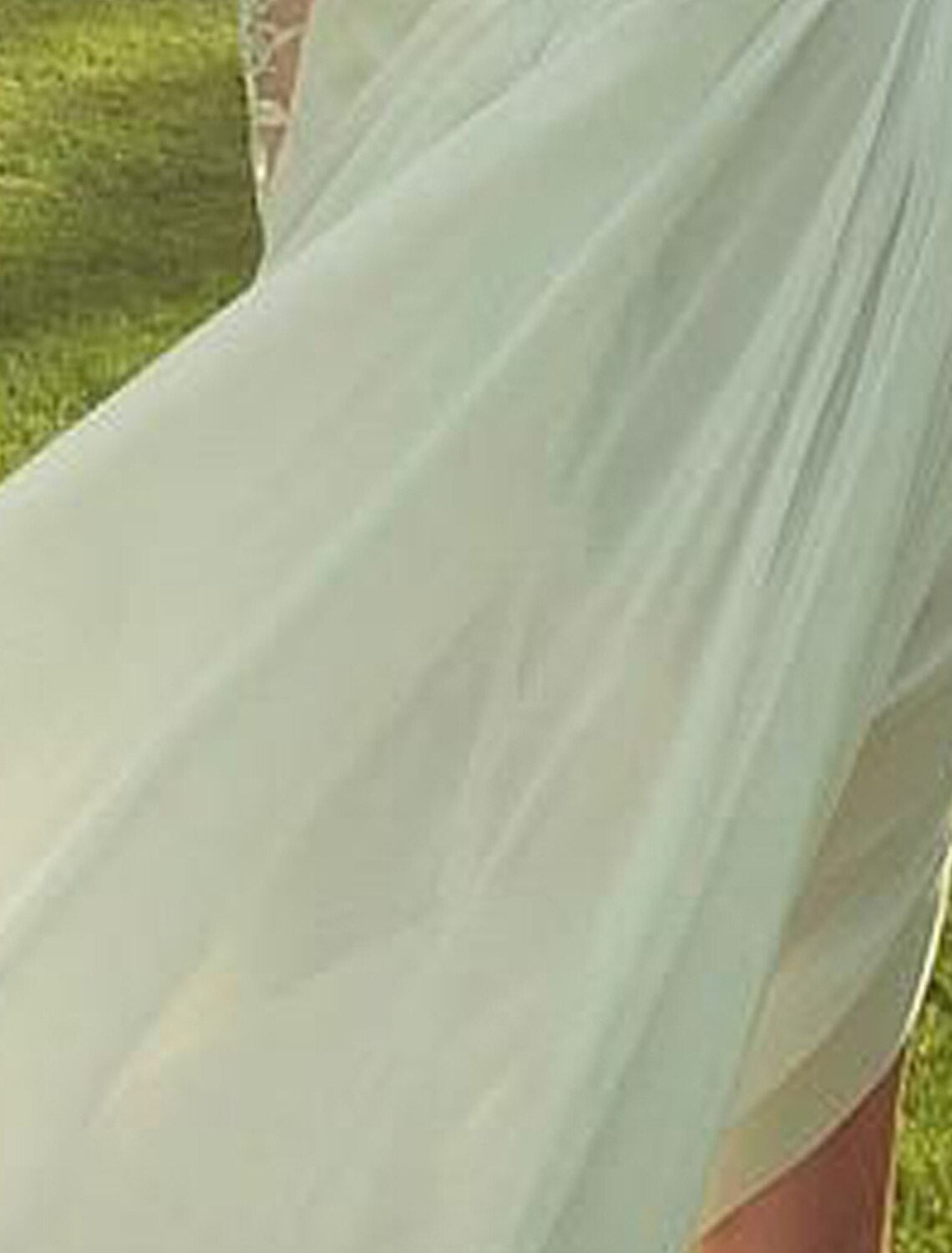 Model gracefully posing in the A-line high neck long sleeve chiffon wedding dress.