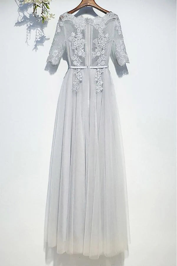 Flowy ankle-length tulle gown with short sleeves, side view on a model.