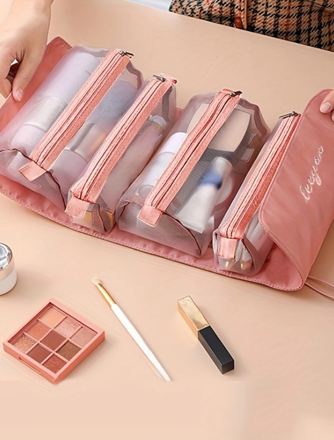 Foldable travel cosmetic bag, open with various toiletries.