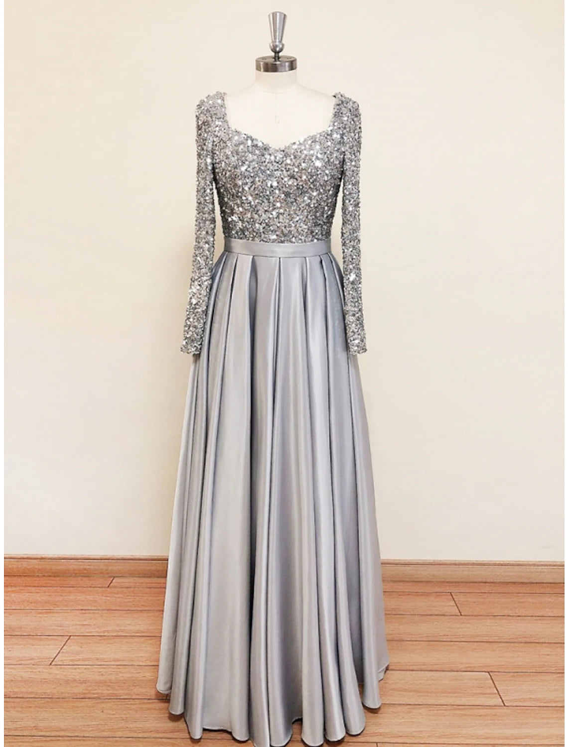 Side view of the elegant black A-line gown, highlighting the long sleeves.