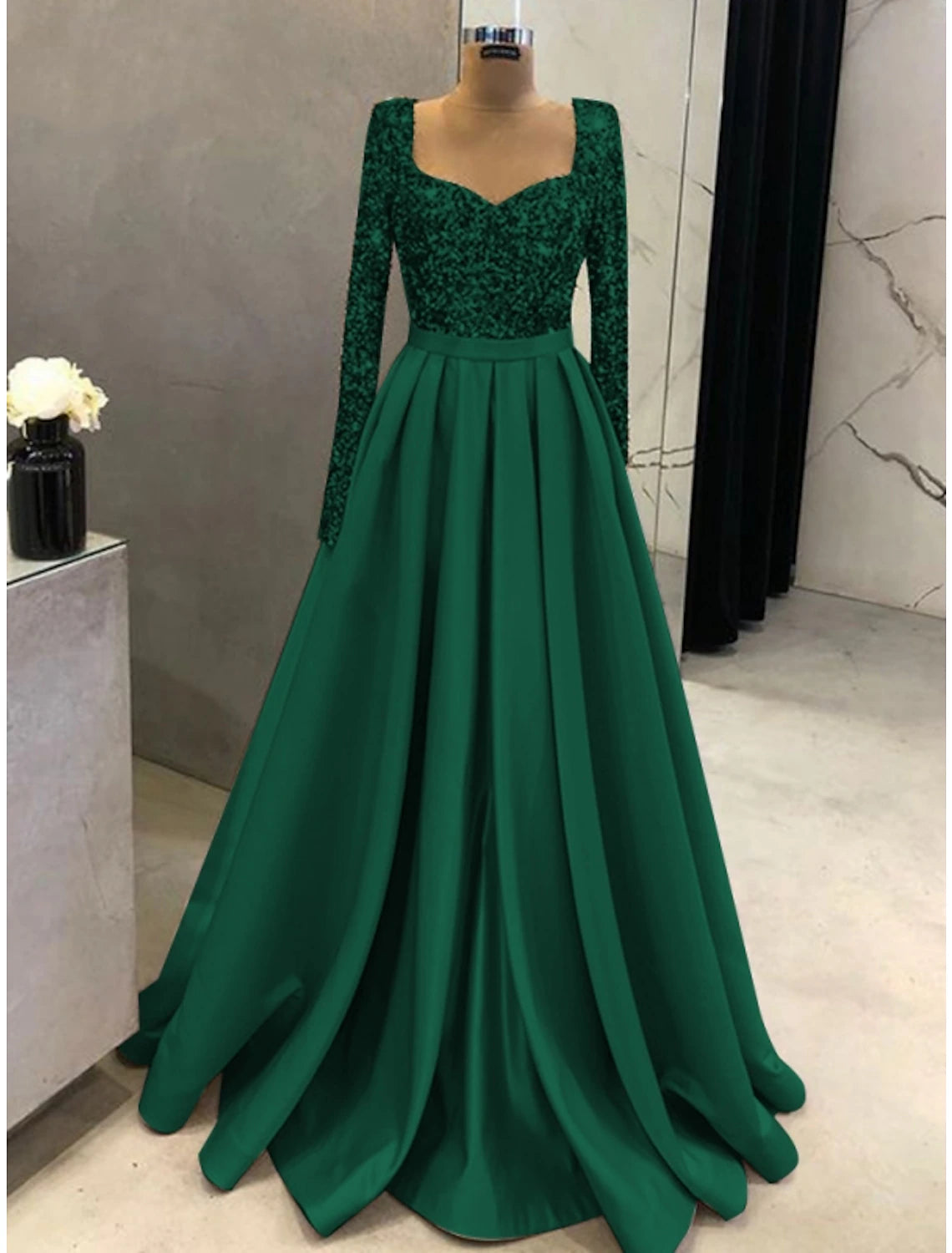 Full length view of the black formal gown, emphasizing its sparkling fabric.