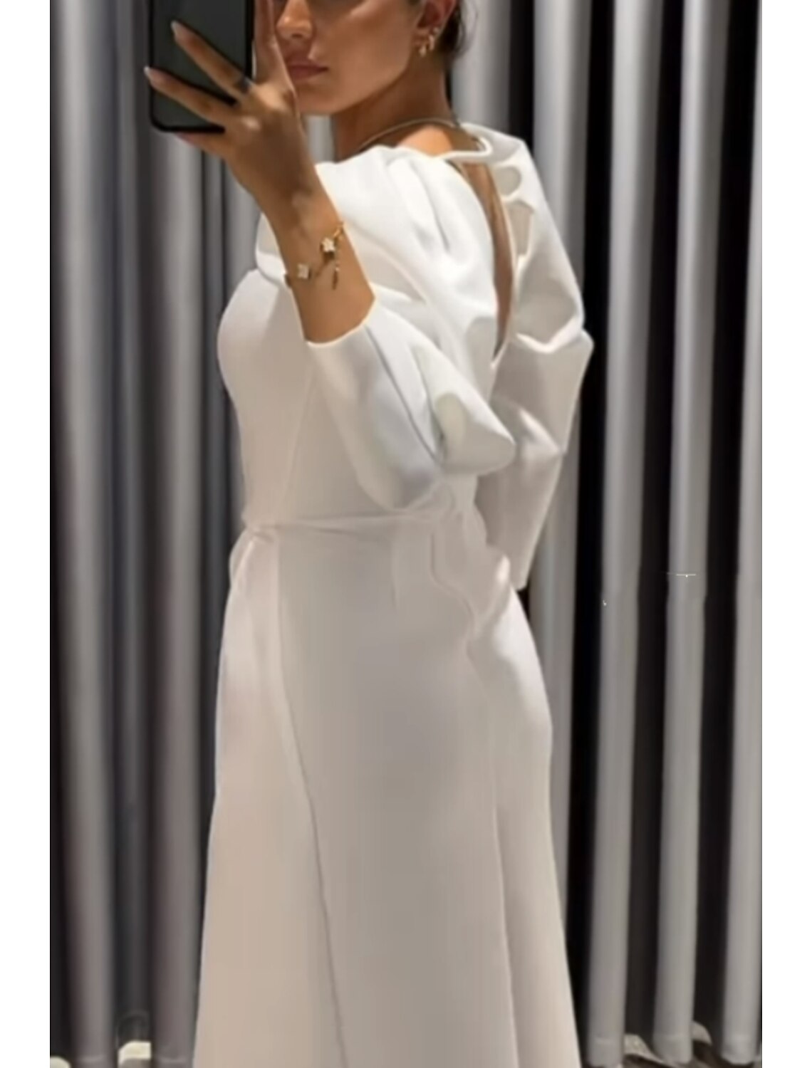 Side view of the black formal dress, highlighting the ruched asymmetrical slit.