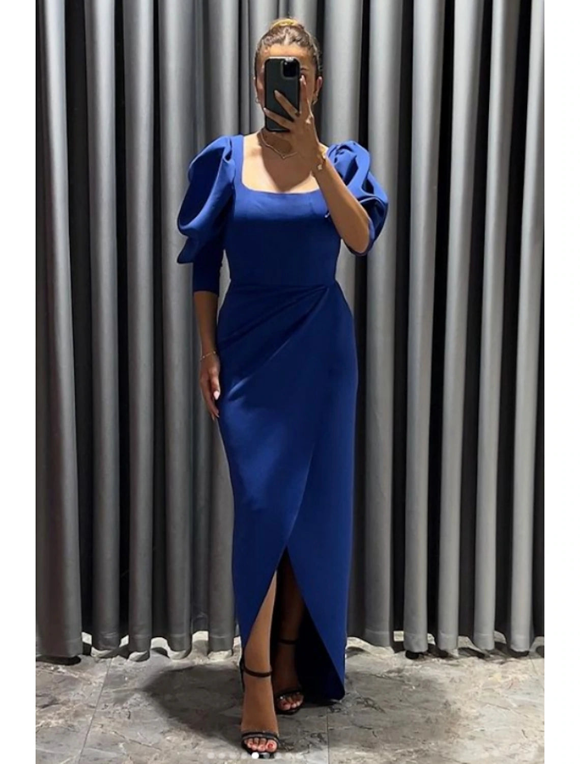 Back view of the elegant black sheath column dress.