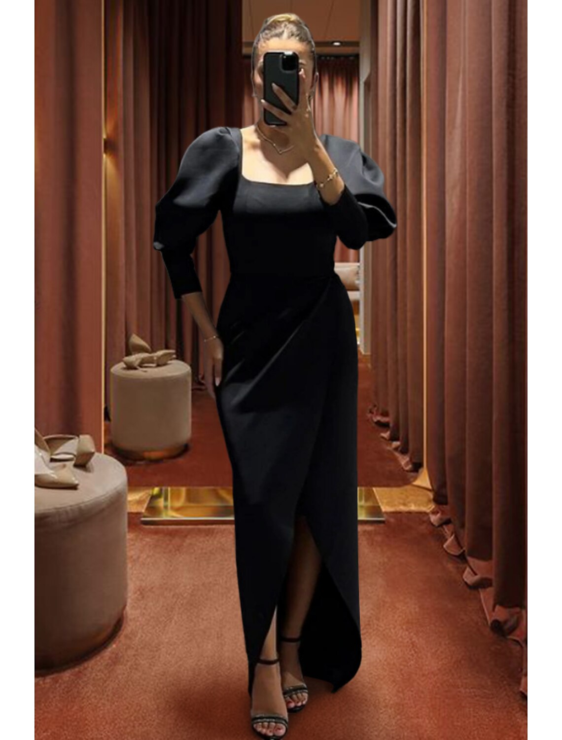 Model walking in the black formal dress, showcasing its flow.