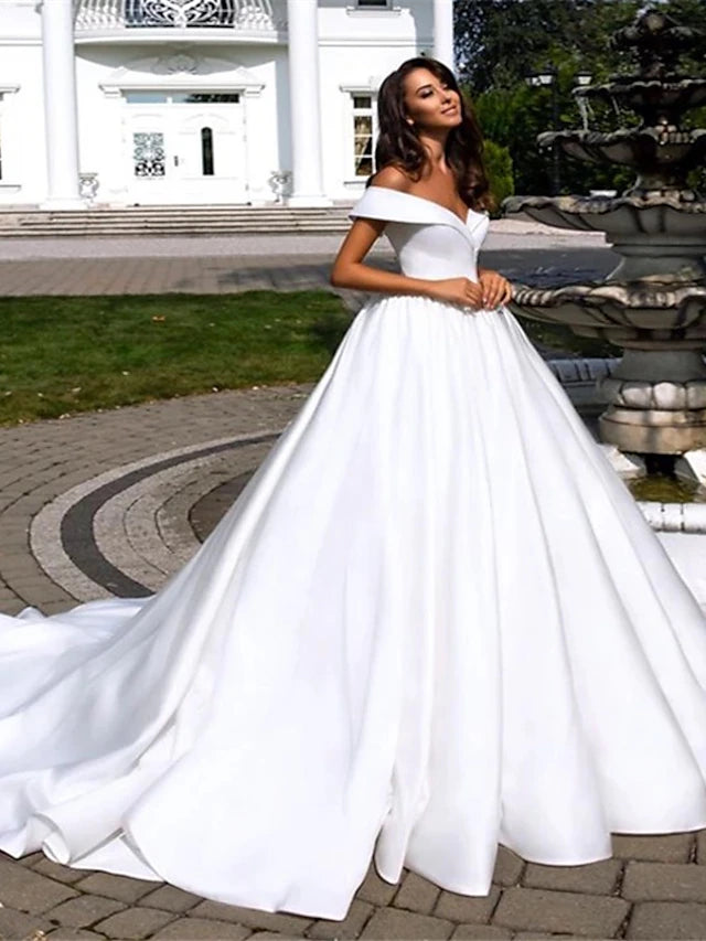 Elegant off-shoulder satin ball gown wedding dress with chapel train and pleats.