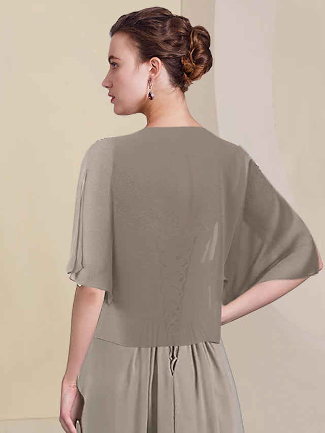 Close-up of the chiffon and lace fabric with ruched appliques on the dress.