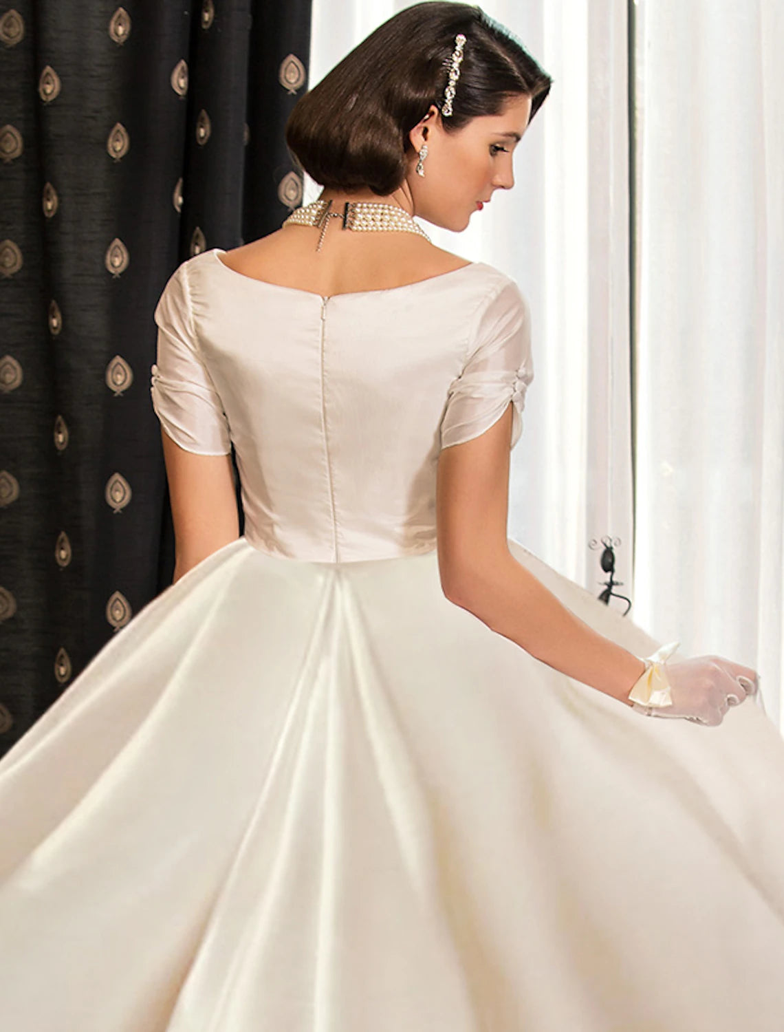 Side view of a formal satin ball gown wedding dress.