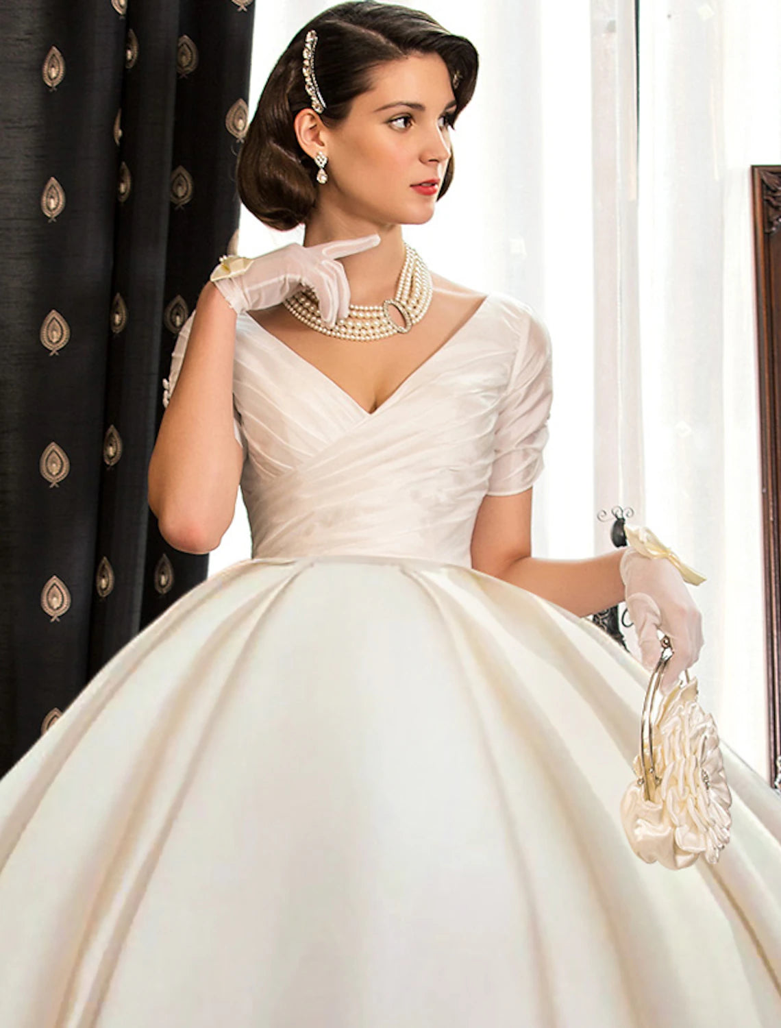 Back view of a ruched satin wedding dress with court train.