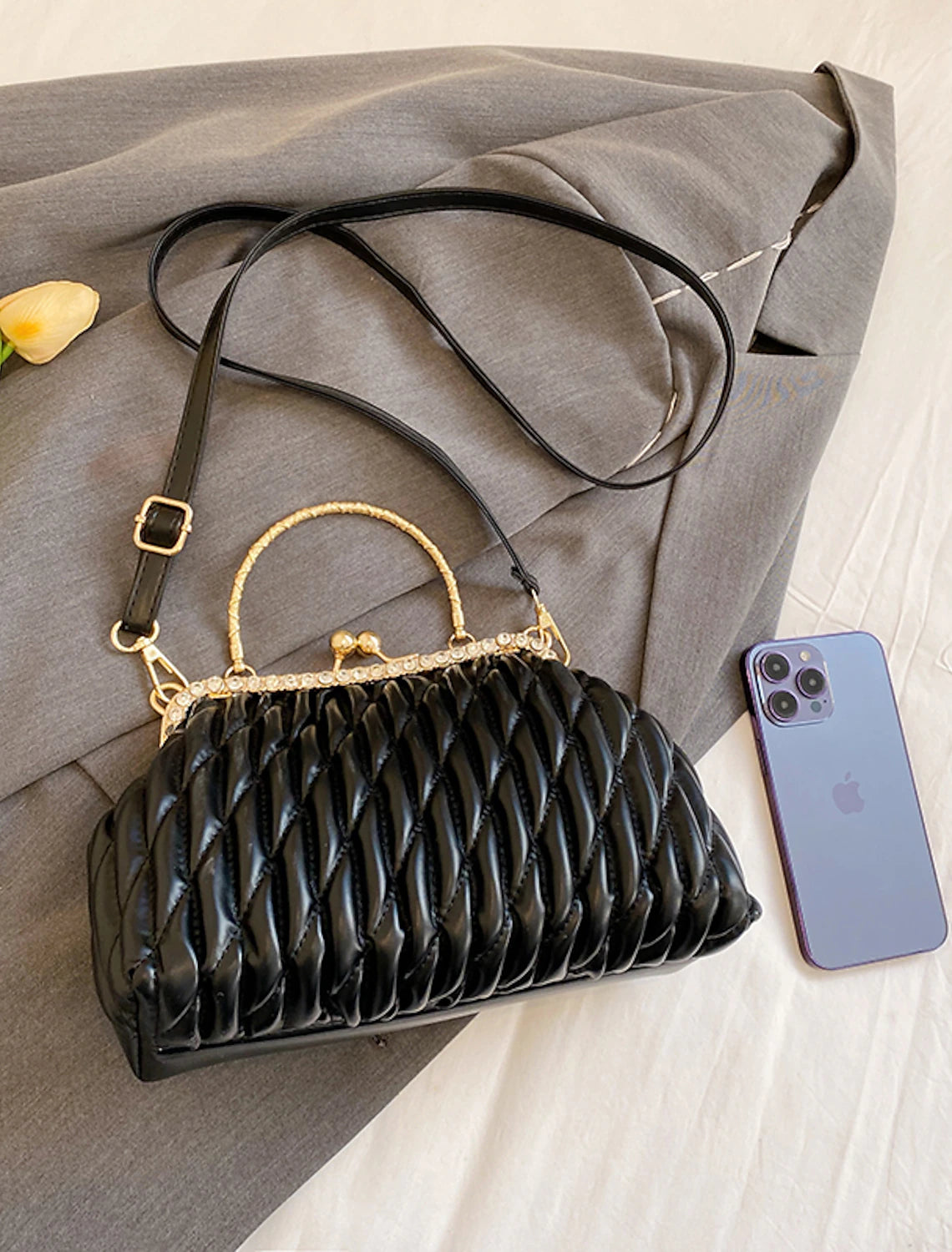 Geometric PU leather evening bag displayed open, showing interior.