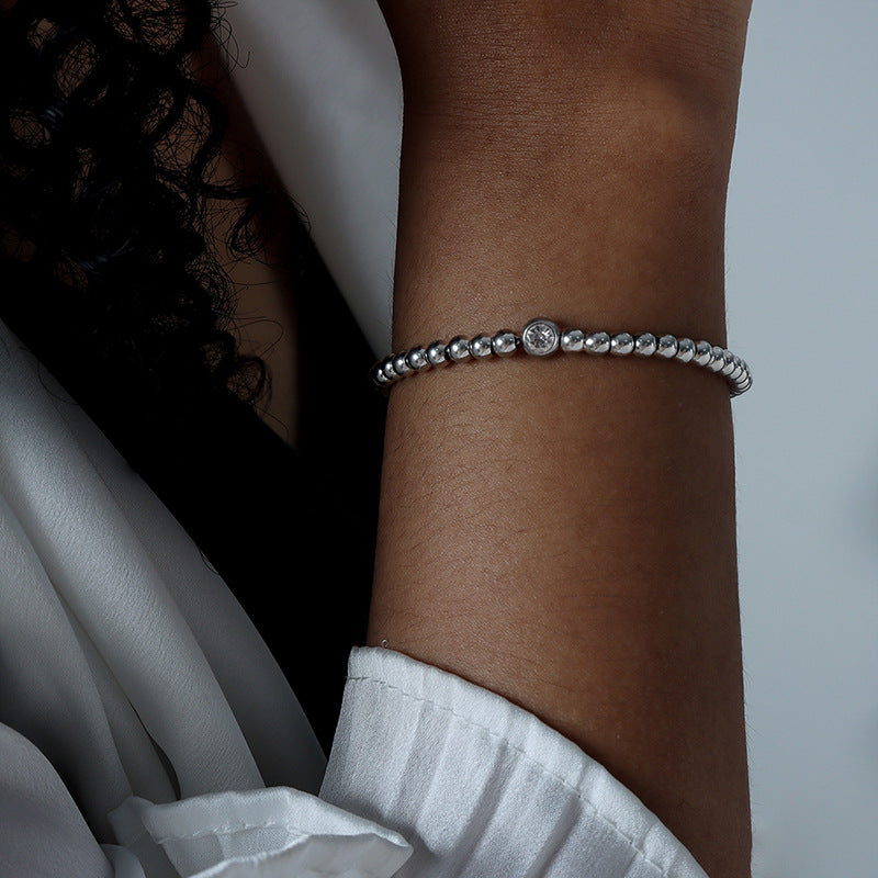 Detailed view of the mosaic zircon embellishments on the jewelry.