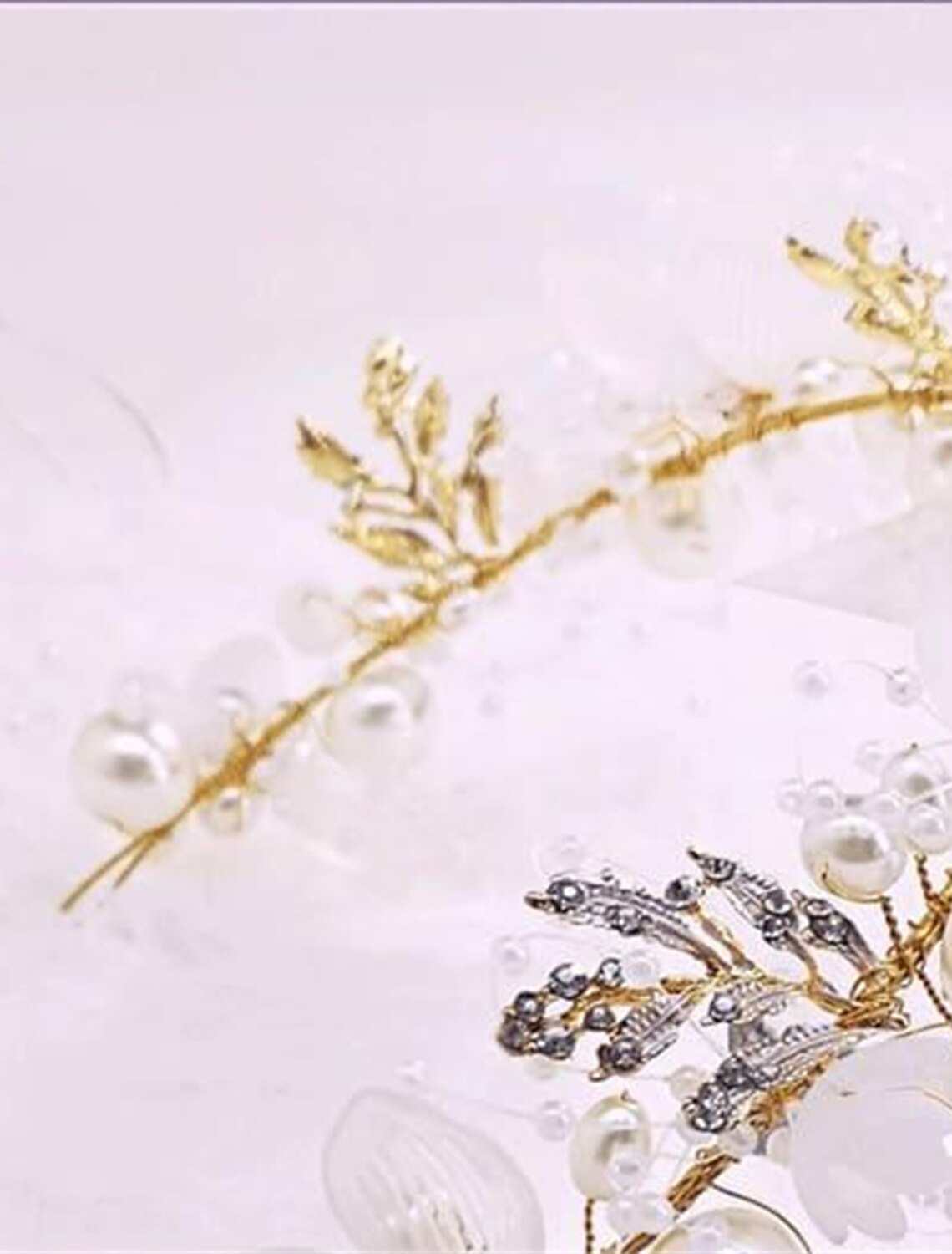 Close-up of delicate white flowers on the garland headband.