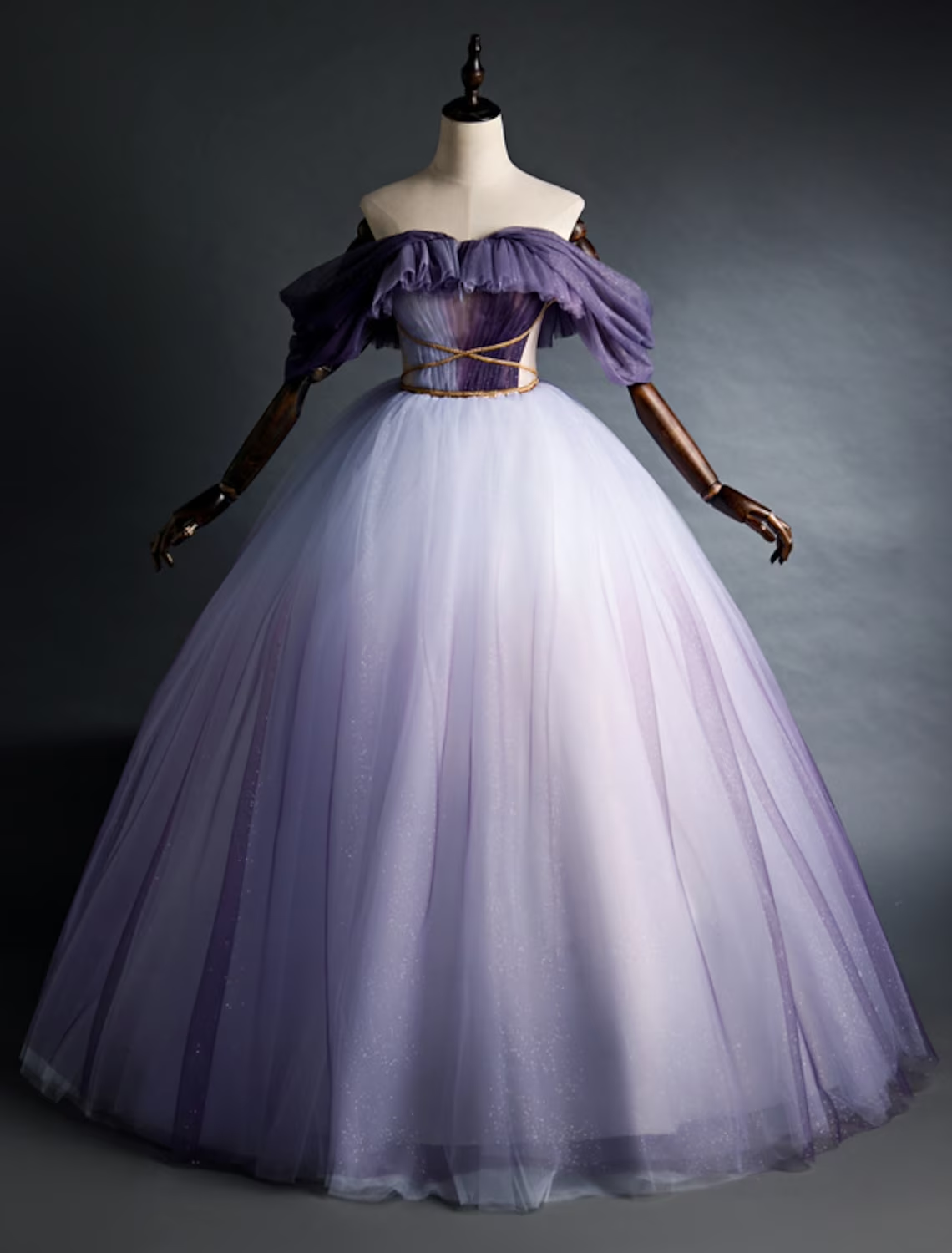 Young girl wearing a purple off-shoulder A-line tulle party dress.