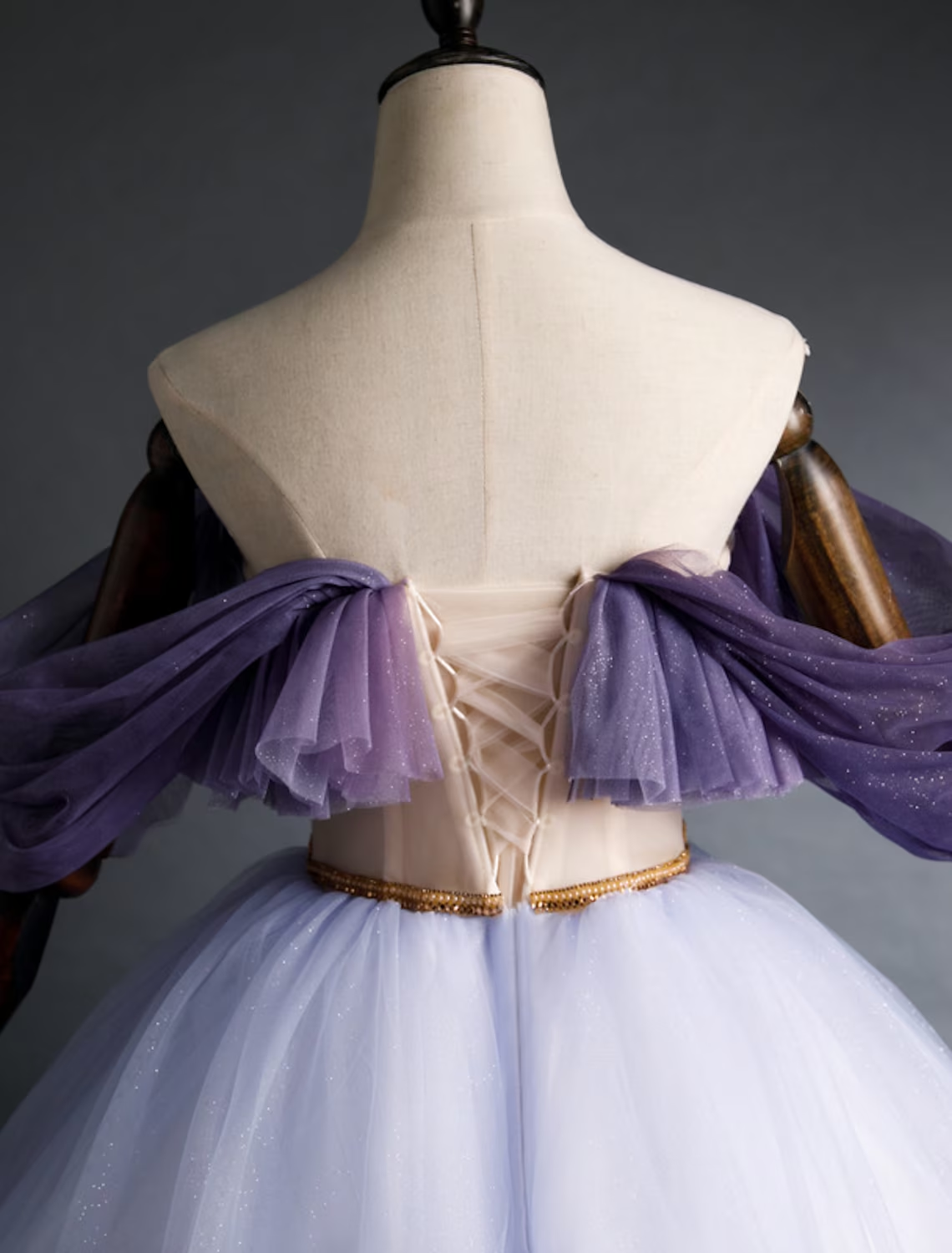 Girl twirling in a purple off-shoulder A-line dress, showing movement.