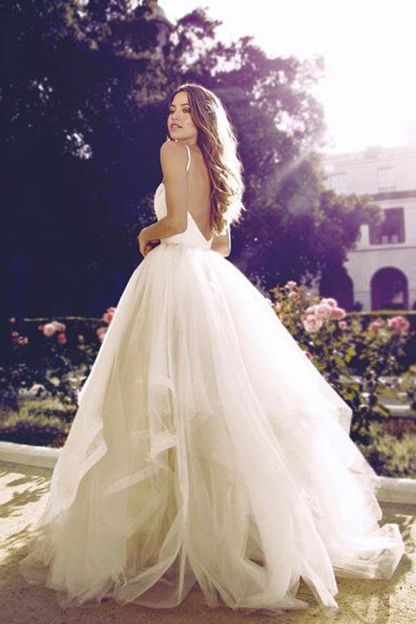 Back view of the glamorous A-line ivory tulle wedding gown, showcasing its backless design.