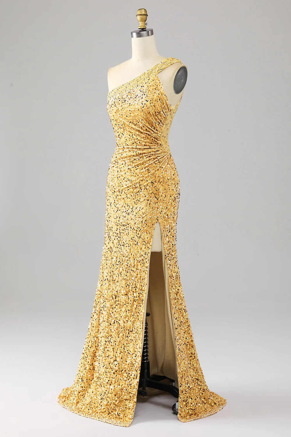 Close-up of the golden sequin fabric and one-shoulder detail on a mermaid prom dress.