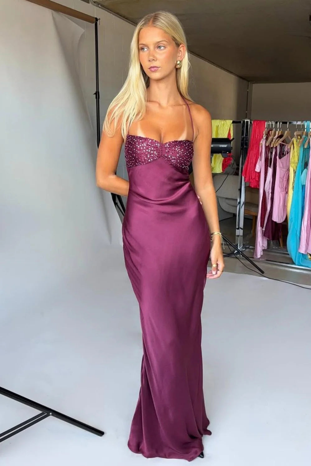 Plum purple satin mermaid maxi dress with halter neckline and beaded bodice.