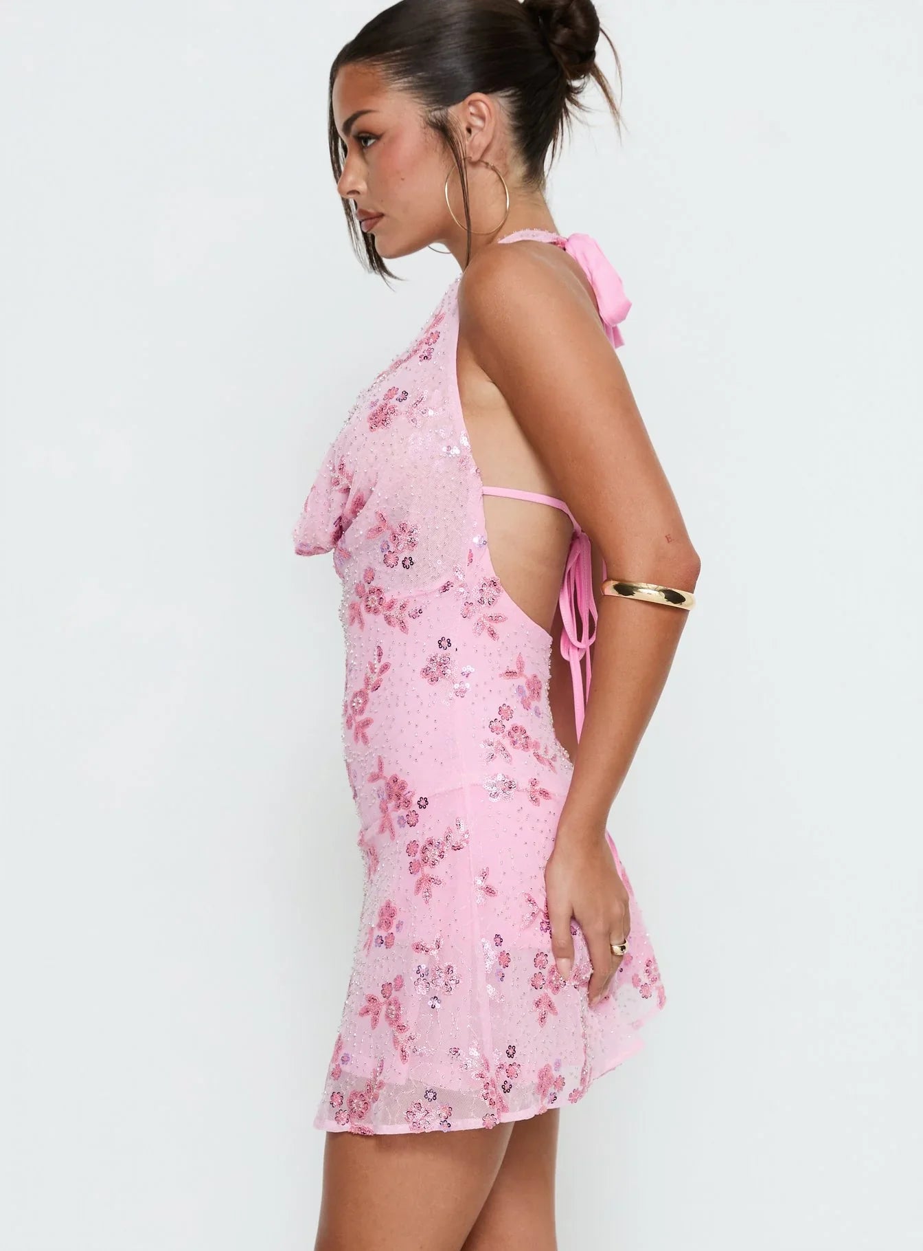 Close-up of floral sequin embellishments on pink dress.