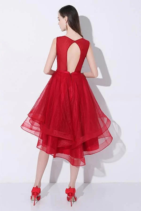 Close-up of the red sequin fabric and open back detail of the high-low dress.