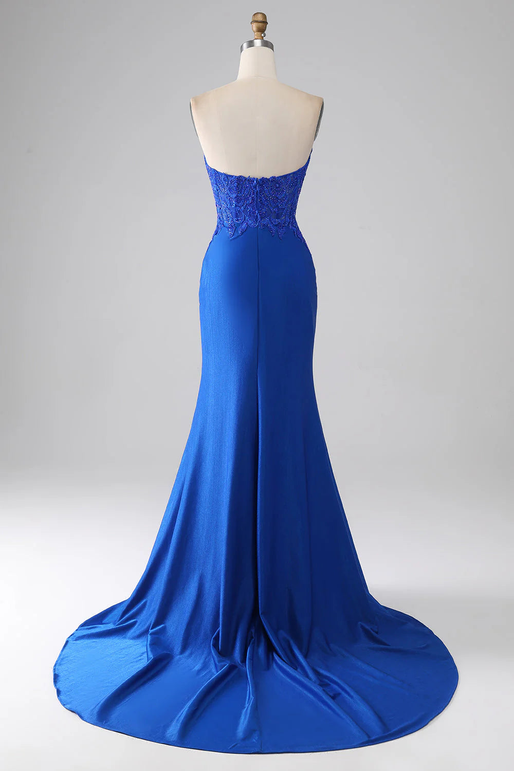 Back view of a royal blue mermaid gown, showcasing the elegant train and applique details.