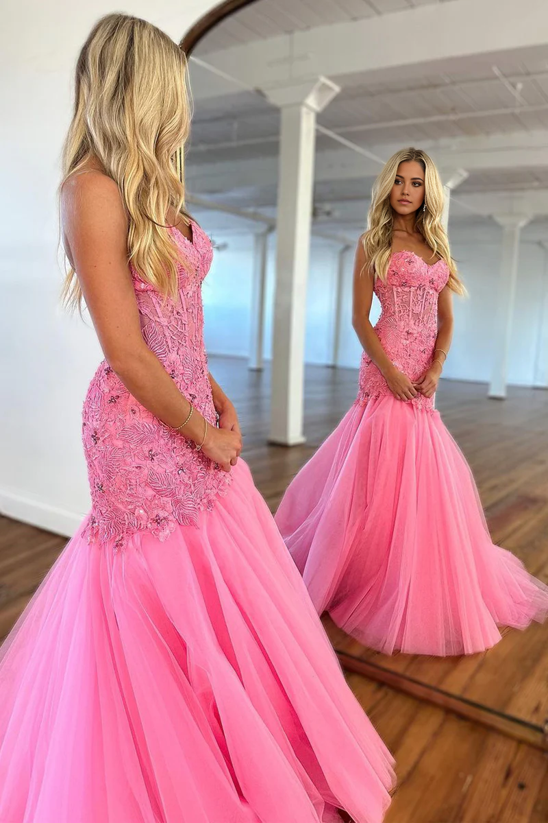 Close-up of delicate appliques on a pink tulle prom dress.