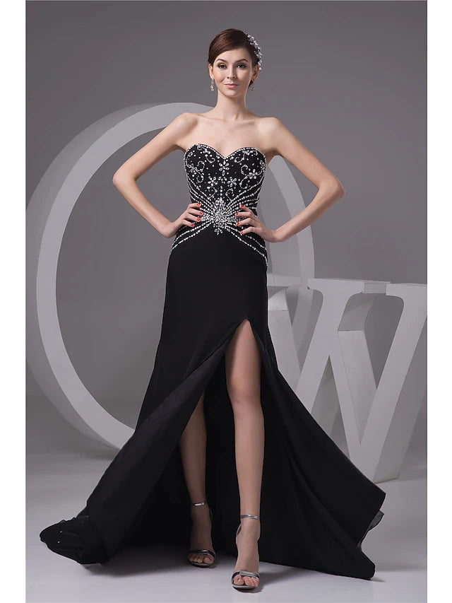 Model wearing a glamorous mermaid sweetheart evening gown with beading and a slit.