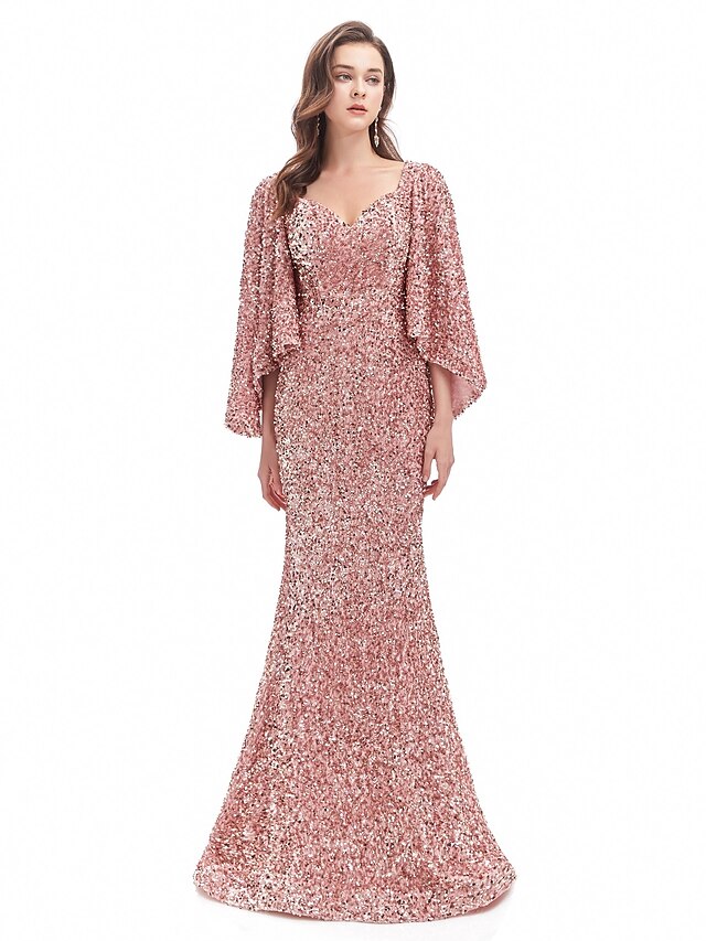 Model wearing a sparkling long sleeve mermaid trumpet evening gown with a sweetheart neckline.