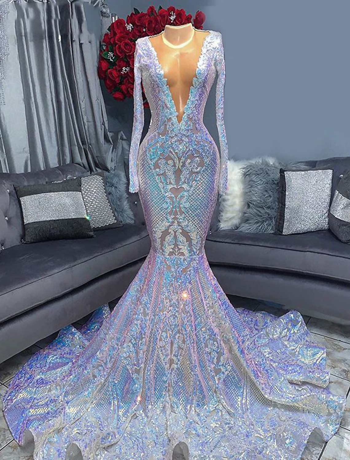 Front view of a glamorous sequined mermaid trumpet evening gown with a V-neck and long sleeves.