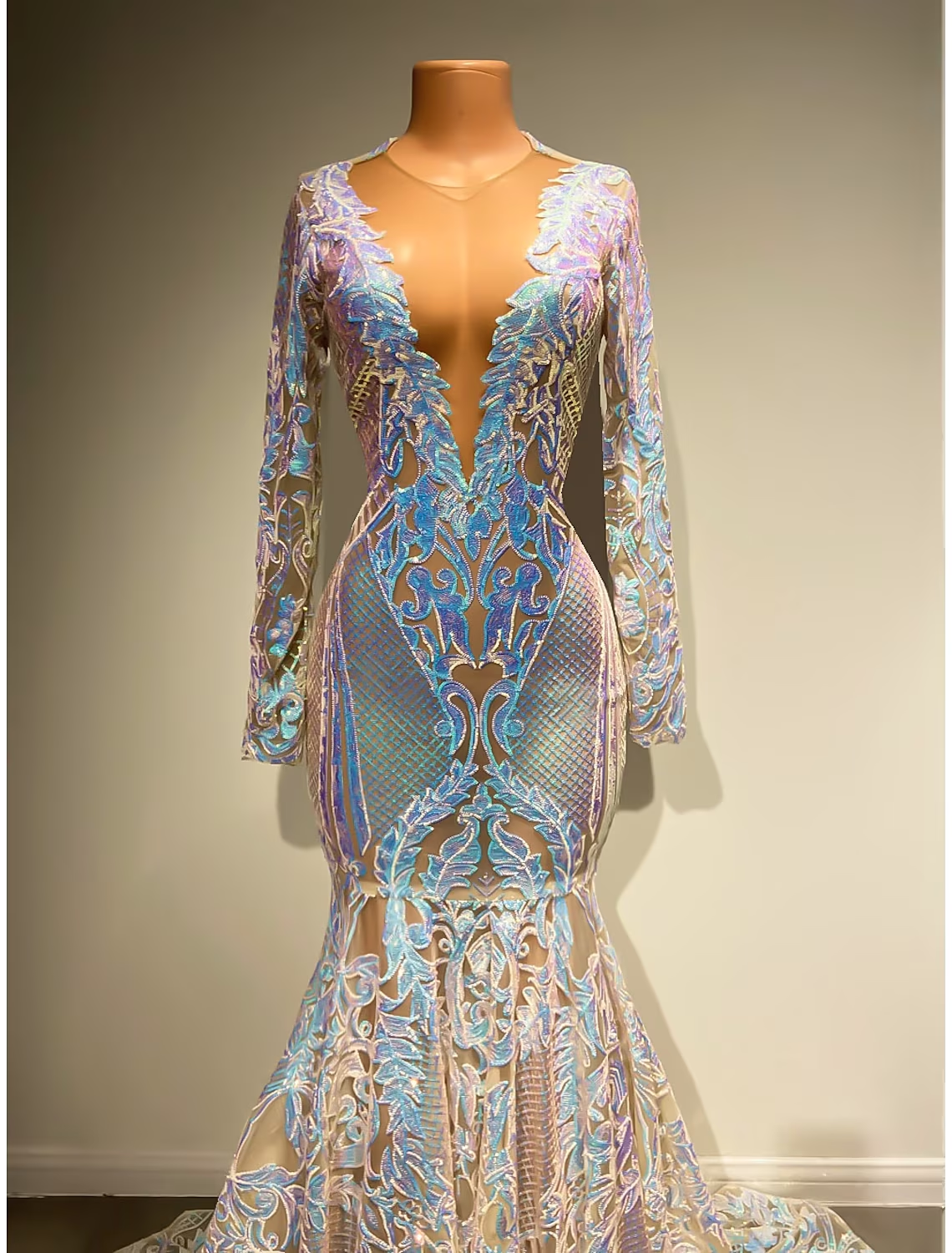 Back view of the elegant sequined evening gown, showcasing the long sleeves and train.